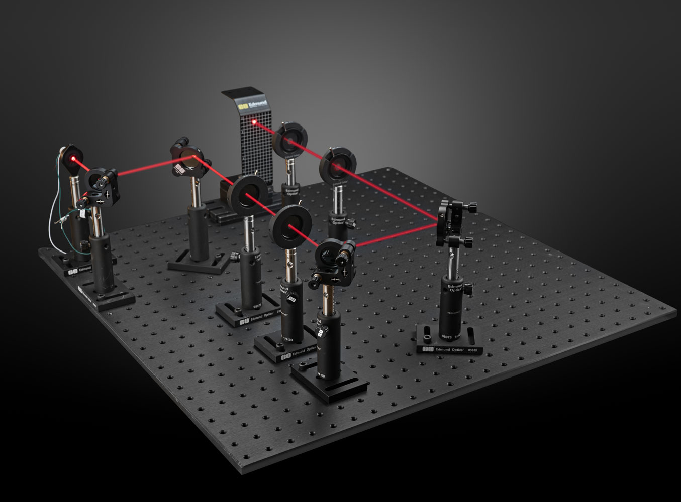 Image of an optical lab setup with a laser diode and mechanical components like mounts, mirrors and irises.